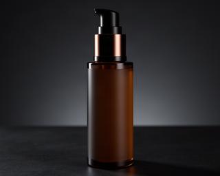 Retinol night serum pump bottle on dark surface